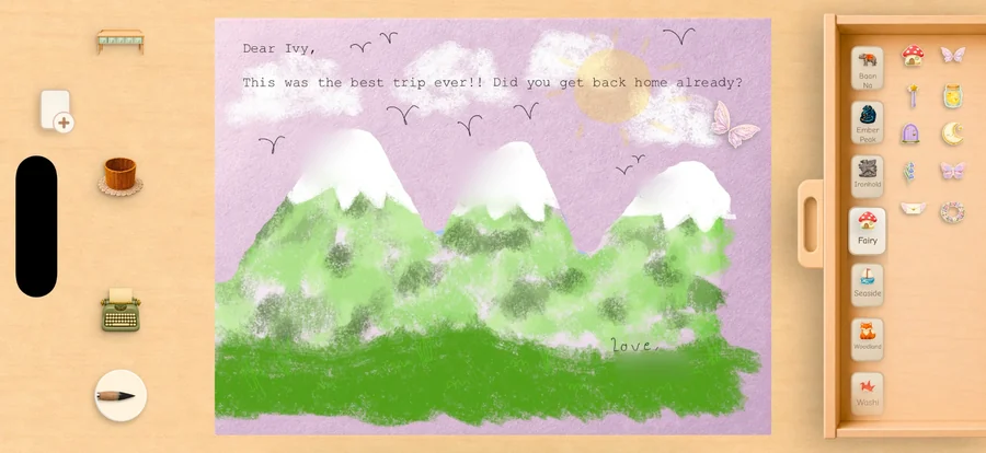 A letter being made on an iPhone, turned sideways: green mountains painted on lilac paper, with the sticker drawer open beside it